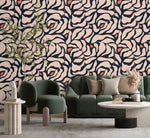 Botanical extravaganza wallpaper with cream navy oversized swirling leaves and orange buds; green bouclé sofa in living room