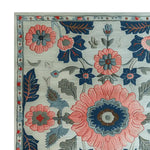 Top view of a beautifully designed hand-tufted area rug featuring a vibrant floral pattern in pink and blue hues. Perfect for adding a touch of elegance to any living room, this wool rug showcases intricate botanical details that make it a standout piece among floral rugs.