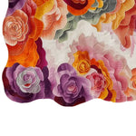 Vibrant and colorful hand-tufted area rug featuring an abstract floral pattern in shades of purple, orange, pink, and green, capturing a modern and artistic design.