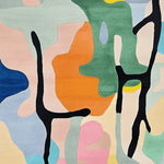 This vibrant area rug features an abstract design with a mix of bold colors including orange, green, blue, and pink. Perfect for adding a contemporary touch to your living room, this hand-tufted wool rug offers a unique pattern that stands out among living room area rugs and rugs for living room decor.