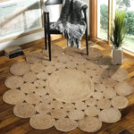 The Bria Natural Jute Round Area Rug beautifully enhances a living space with its intricate circular pattern. Ideal as a large area rug for the dining room or living room, this jute rug's natural texture adds warmth and style. Perfect under a dining table or as a statement piece, this round rug complements the hardwood flooring and modern decor.