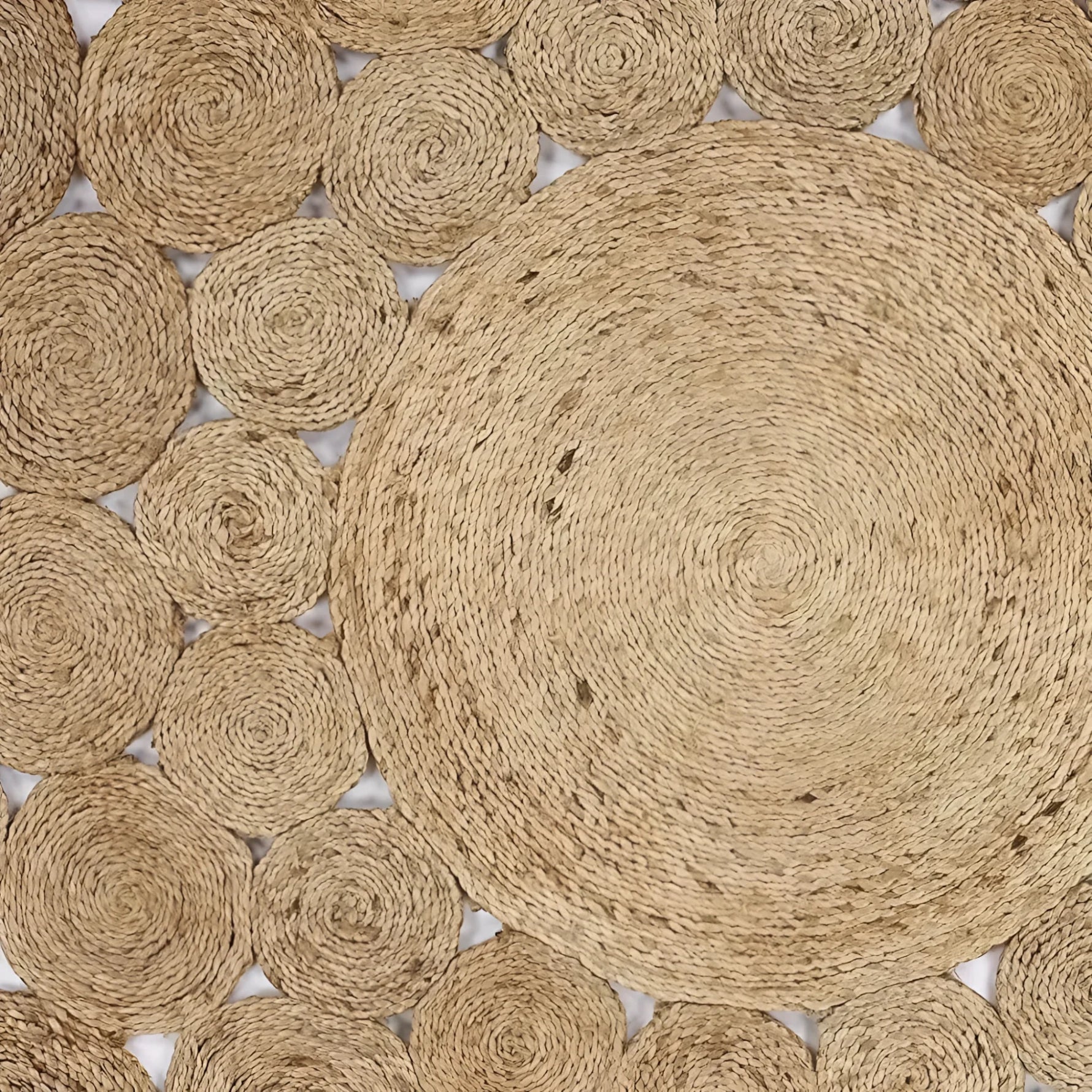 The Bria Natural Jute Round Area Rug features a unique circular design with intricate woven patterns, ideal for adding a rustic touch to your dining room. This large area rug is perfect for placing under a dining table or enhancing the coziness of your living room. The natural fibers of this Jute rug not only offer durability but also complement a variety of home decors.