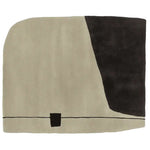 A contemporary hand-tufted wool rug with a minimalist design, featuring a large sand-colored field contrasted by a bold black geometric shape. Ideal for adding a modern touch to living room area rugs, this piece stands out with its unique brutalist style, perfect for those seeking distinctive area rugs for living room spaces.