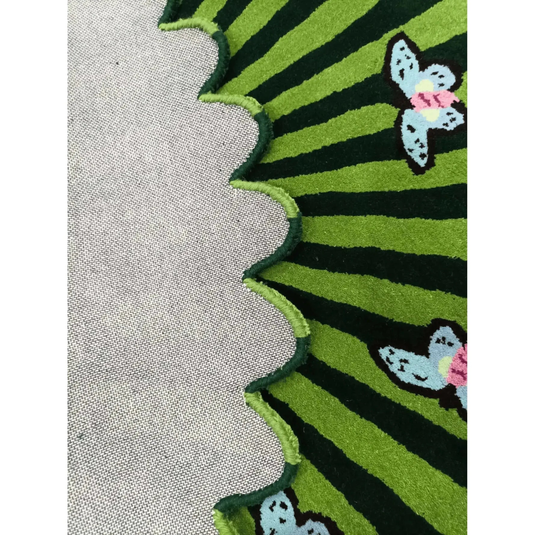 Close-up of the Butterflies over Flower Hand Tufted Wool Rug in green, showcasing a vibrant design with butterflies and a scalloped edge. Perfect for adding a touch of nature to your office or large living room. This area rug features a durable wool texture, ideal for living room decor.