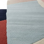 Close-up of a textured rug with a geometric pattern on a white background