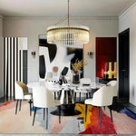 calming colors hand knotted wool rug with pastel and vivid abstract sections in formal dining room with crystal chandelier