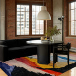 calming colors hand knotted wool rug with bold multicolor abstract brushstrokes in navy red yellow in loft dining room