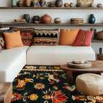 A beautifully styled living room featuring a Cambodian Heritage Wool Hand Knotted Area Rug. This vibrant square rug showcases intricate patterns and rich colors, complementing the cozy ambiance with a modern sofa and decorative cushions. Ideal for enhancing any living room, this wool rug is perfect for those seeking stylish area rugs for living room spaces.