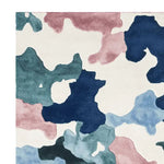 Top view of the Camouflage Cloud Dance Hand Tufted Rug, showcasing a vibrant abstract pattern with shades of blue, pink, and cream. This wool area rug is perfect for contemporary living rooms, adding a modern touch to large spaces.