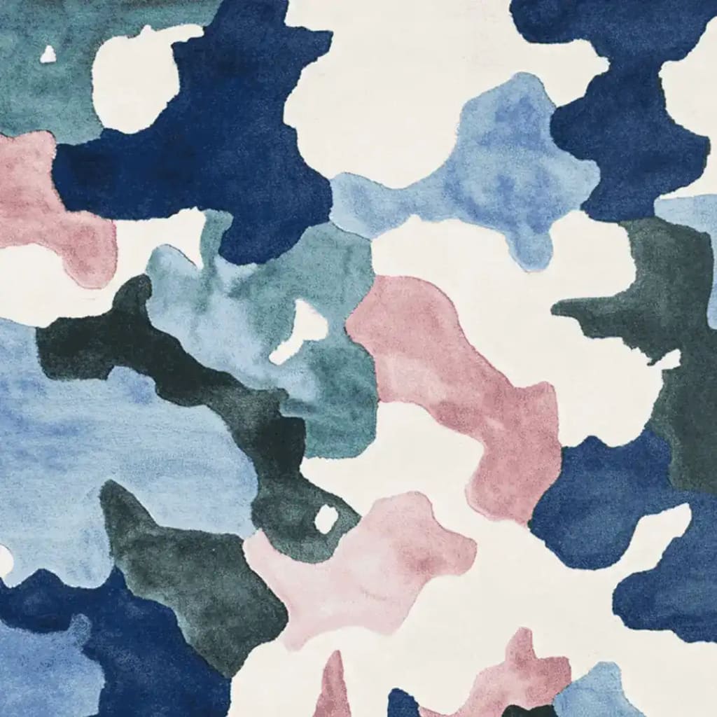 Top view of a contemporary wool area rug featuring an abstract camouflage pattern in shades of blue, green, pink, and white, perfect for large living room spaces.