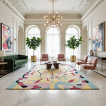 Modern living room with a colorful rug, green sofa, and decorative plants.