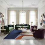 Modern living room with green sofas, purple chairs, and a colorful wool rug.
