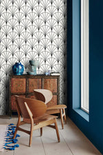 Carved cabinet and wooden chairs against monochrome round line wallpaper of deco fan arches