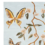 A beautifully designed area rug featuring a hand-tufted wool pattern of vibrant butterflies and delicate flowers. This wool rug is perfect for adding an artistic touch to your living room, making it a stylish choice for those seeking unique living room area rugs.