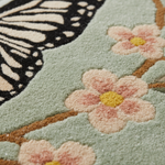 close up shot of a tufted wool rug butterfly.