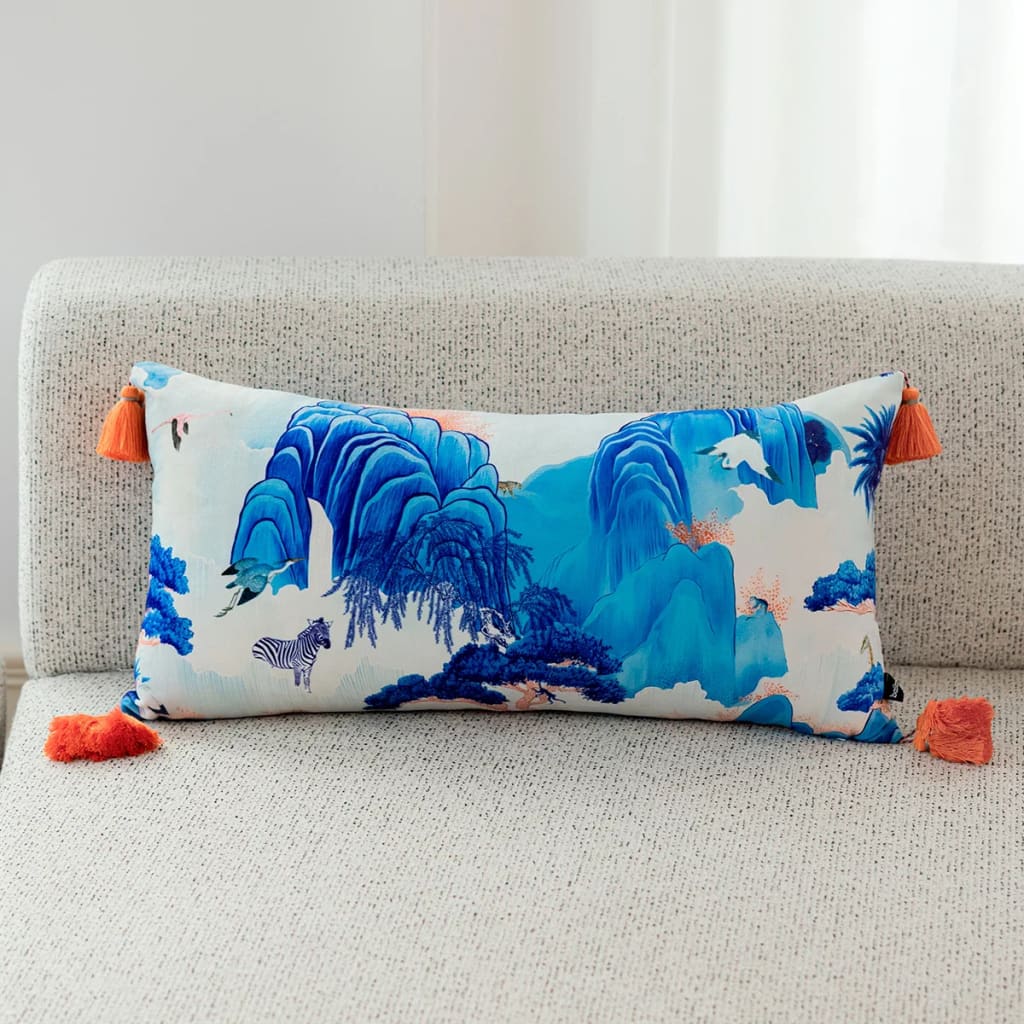 Celestial Azure Enchantment Throw Pillow with vibrant blue mountain design and orange tassels, perfect for home decor