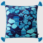 Celestial Chinoiserie throw pillow featuring vibrant blue and white pagoda and tree designs on a navy background, accented with decorative tassels.