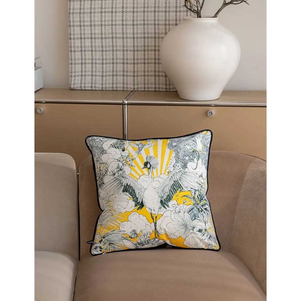 Celestial crane throw pillow with vibrant yellow and blue design, featuring floral elements and a serene backdrop, perfect for home decor.