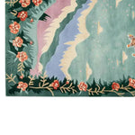 A stunning hand-tufted wool area rug showcasing a celestial drift design with vibrant floral patterns and a playful tiger motif on a soft, multicolored background. Perfect for adding a touch of elegance and whimsy to any room.