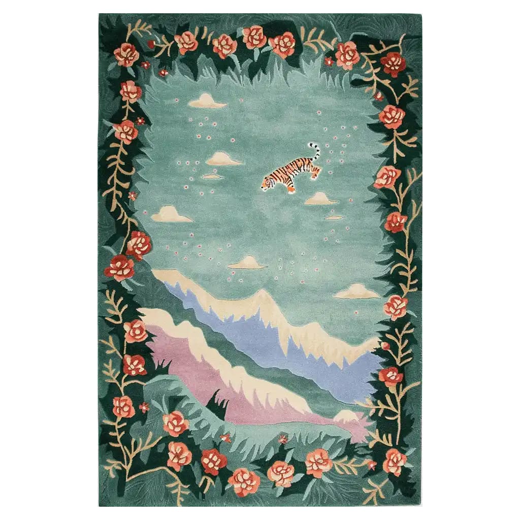 A vibrant hand-tufted wool area rug featuring an abstract design with a tiger floating among clouds, surrounded by colorful floral borders and mountainous landscapes. The Celestial Drift rug adds a whimsical touch to any room.