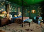 Luxurious bedroom with green walls, floral patterns, and elegant furniture.