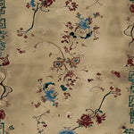 A close-up view of the Celestial Floral Dream Hand Knotted Area Rug, showcasing intricate floral designs in rich blue, burgundy, and cream tones. This wool rug offers a luxurious touch, perfect for adding elegance to any living room decor.