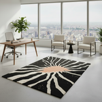 Living room with a black and white patterned rug, wicker chair, and bookshelves.
