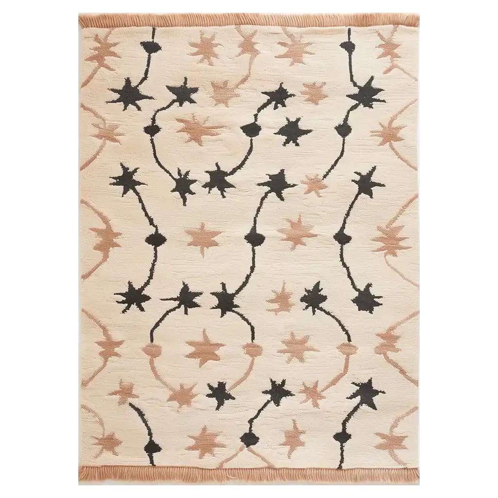 Top view of the Celestial Rhapsody Knotted Wool Rug featuring a cream background with an abstract star pattern in black and beige tones, ideal for adding a touch of elegance to any space.