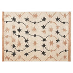 Top view of the Celestial Rhapsody Knotted Wool Area Rug showcasing a unique starry pattern in black and brown on a light background, ideal for adding a celestial touch to any room.