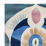 Close-up view of the Celestial Spiral Hand Tufted Rug showcasing its abstract design with rich blue, beige, and pink tones. This contemporary wool rug is perfect for adding a stylish touch to any living room. Ideal as an area rug or living room rug in an 8x10 size.