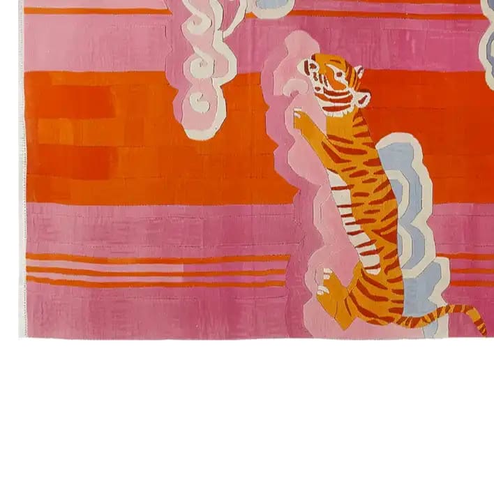 Vibrant abstract area rug featuring a celestial tiger design with bold pink, orange, and white hues. The hand-tufted wool rug showcases an artistic depiction of a tiger amidst swirling patterns, adding a modern touch to any space.