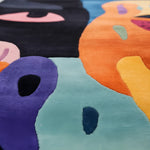 Colorful abstract rug with various shapes and patterns