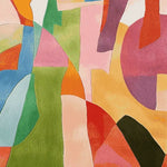 A vibrant abstract area rug featuring a harmonious blend of bold colors and geometric shapes. This hand-tufted wool rug is perfect for adding a contemporary touch to a living room space. Ideal as a living room rug in an 8x10 size, it combines artistry with comfort, making it a standout piece in modern home decor.