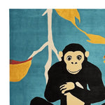 Cheeky Chimp Chill Hand Tufted Area Rug featuring a playful monkey design on a vibrant blue background. This contemporary wool rug is perfect for adding a touch of whimsy to large living room spaces.