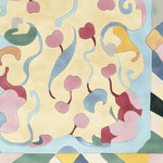 Top view of the Cherry Pop Swirl Hand Tufted Rug, a contemporary area rug perfect for living rooms. This wool rug features a vibrant and abstract design with swirling patterns and cherry motifs in soft pastel colors, adding a touch of modern elegance.