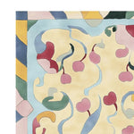 A vibrant area rug featuring a contemporary design with swirling cherry motifs in shades of red, pink, and green on a soft cream background. This wool rug adds a playful touch to any living room, making it an ideal choice for those seeking unique rugs for living room decor.