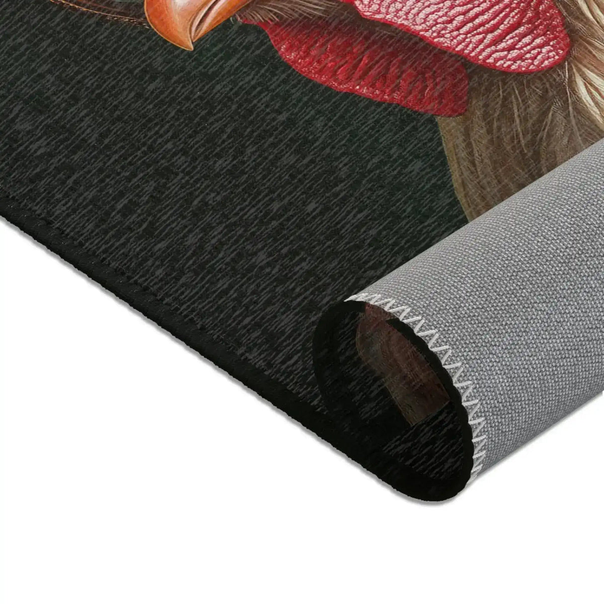Corner fold of dark charcoal print with red rooster comb top detail and grey woven backing edge, Chic Renaissance Chicken Accent Rug
