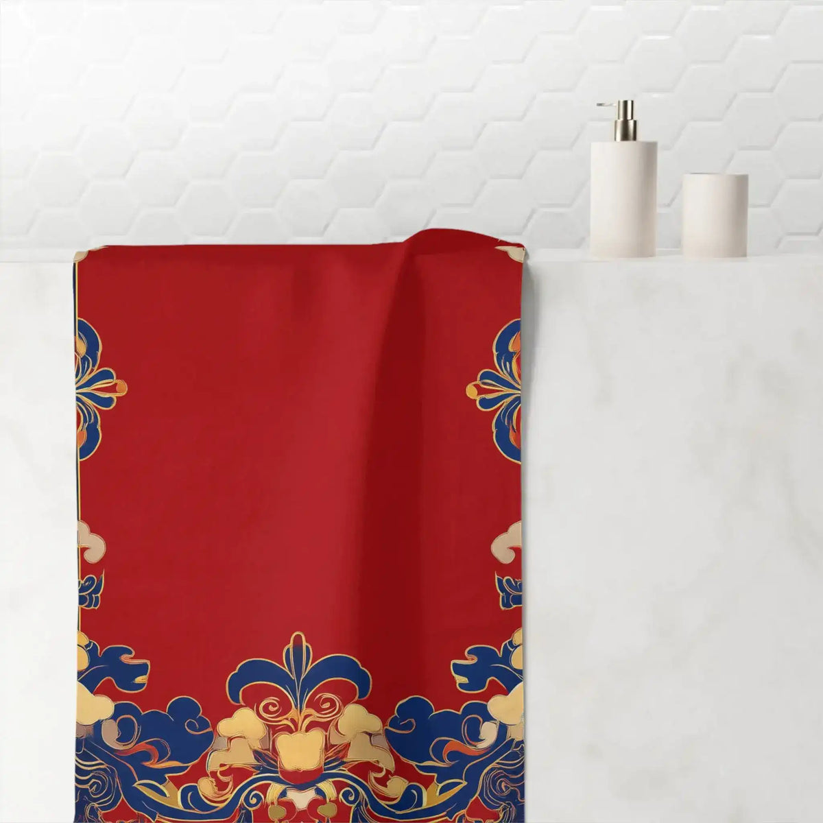Chinoiserie Floral Border Red and Blue Bath Towel draped over bathroom shelf with white hexagon tile backdrop and soap dispensers