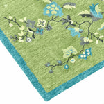 Green rug with floral patterns on a white background