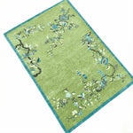 Decorative rug with floral patterns on a green background