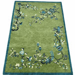 Green rug with floral patterns on a white background