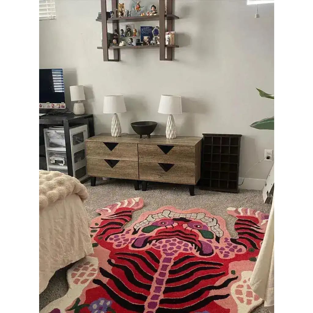 A vibrant Chinoiserie Pink Tibetan Tiger tufted wool rug adds a pop of color to a cozy living room setting. This large area rug, ideal for living room area rugs, showcases an abstract tiger design, perfectly complementing the modern decor with its intricate patterns and rich colors.