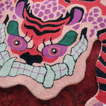 Close-up view of a Chinoiserie Pink Tibetan Tiger Tufted Wool Rug, showcasing its vibrant abstract tiger design. Perfect as a wool rug to add a unique touch to living room area rugs, enhancing large living room decor.