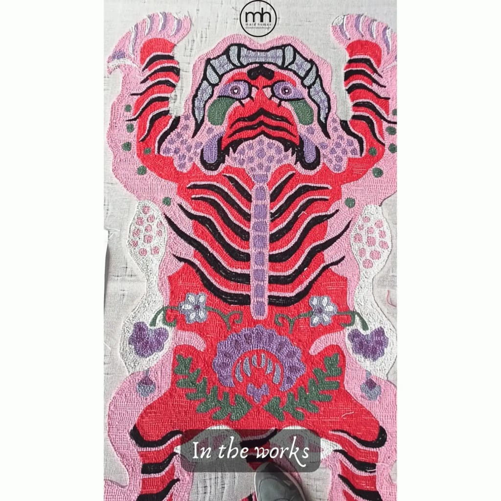 This vibrant Chinoiserie Pink Tibetan Tiger Tufted Wool Rug is an eye-catching addition to any living room. Featuring an abstract tiger motif in bold pink, red, and purple hues, this area rug is perfect for those seeking large living room rugs that make a statement. The intricate wool design adds texture and depth, making it an ideal wool rug for stylish interiors.