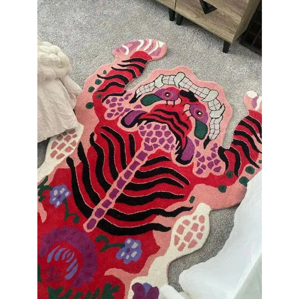 A vibrant Chinoiserie pink Tibetan tiger tufted wool rug displayed in a living room setting. This unique area rug features an abstract tiger design in bold colors, perfect for adding a striking focal point to large living room spaces. Ideal for those seeking eye-catching living room area rugs with a touch of cultural flair.