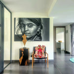 Chic living room featuring a vibrant Chinoiserie Pink Tibetan Tiger Tufted Wool Rug displayed on a sleek wooden chair. The abstract tiger design adds a bold statement to the modern space, enhanced by a striking black-and-white portrait on the wall, perfect for those seeking unique large living room area rugs.