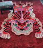 This vibrant Chinoiserie Pink Tibetan Tiger Tufted Wool Rug adds a bold statement to any living room. The area rug showcases a striking abstract tiger design in vivid pink, red, and black shades, perfect for those seeking unique living room area rugs. Crafted from high-quality wool, it offers both durability and style, making it an ideal choice for large living room rugs.