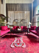 This vibrant living room showcases a Chinoiserie Tibetan Tiger Hand Tufted Wool Rug in pink, adding a bold and artistic flair to the space. Perfect for both living room and dining room settings, this large area rug features an abstract tiger design that stands out against the elegant decor. The wool rug complements the rich red seating and creates a cohesive look in this stylish, well-lit room.