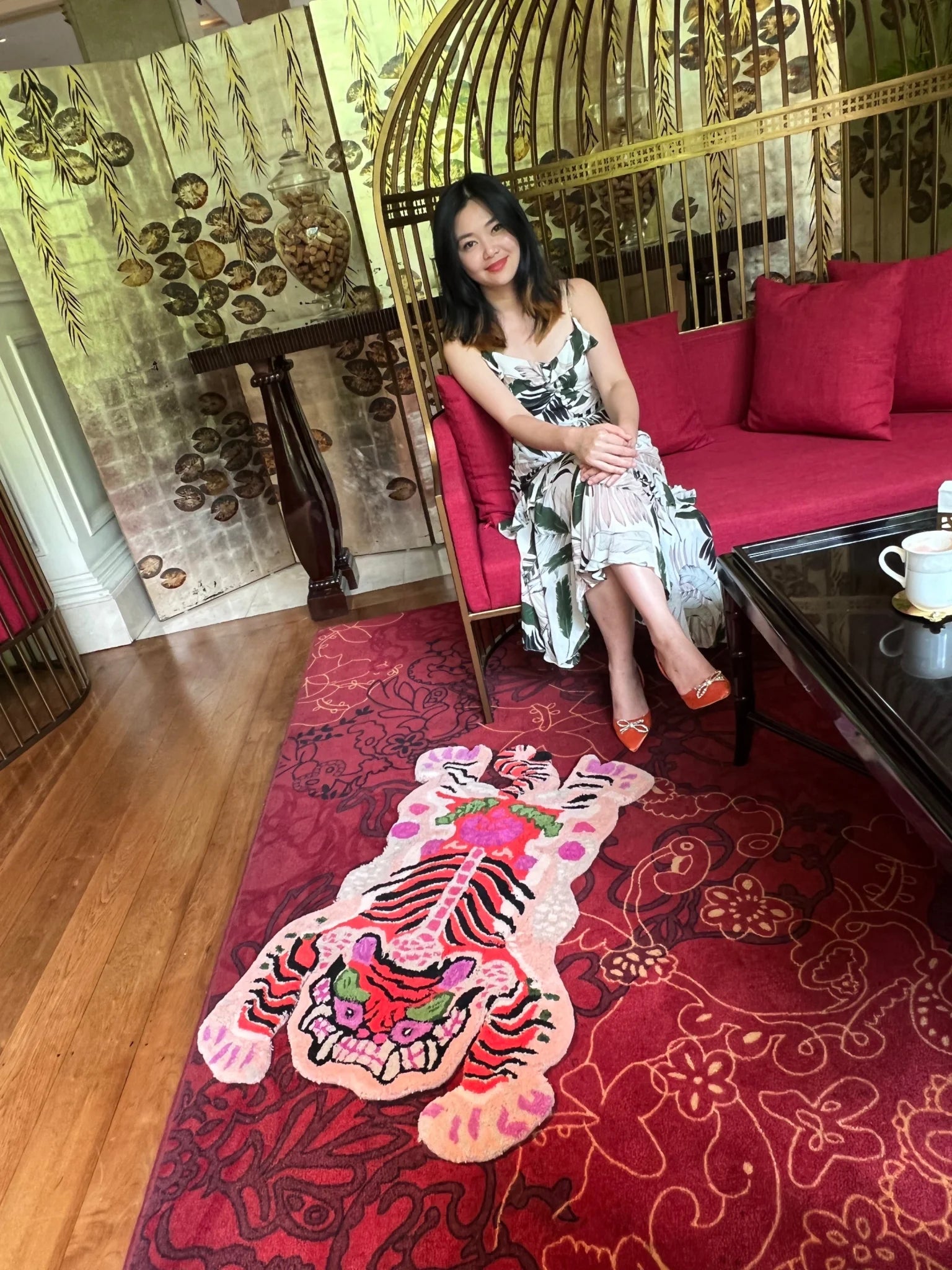 Chinoiserie Tibetan Tiger Hand Tufted Wool Rug in pink displayed in a stylish living room setting. The area rug features an abstract tiger design, ideal for large living room rugs or dining room decor. The vibrant wool rug adds a bold statement to any space.