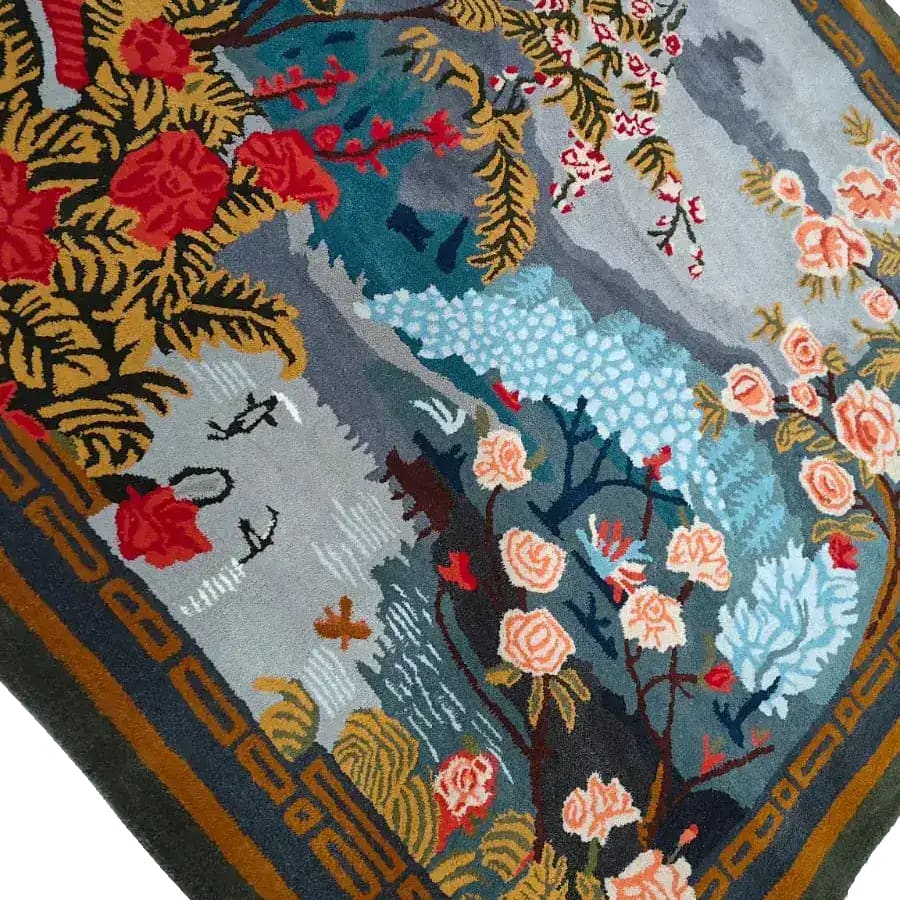 A vibrant Chinoiserie Vista hand-tufted wool rug featuring an intricate floral design with red and peach flowers against a blue and gray background. Perfect for adding elegance to large living room spaces, this square area rug showcases a blend of traditional and modern design elements, ideal for those seeking unique large area rugs for living rooms.
